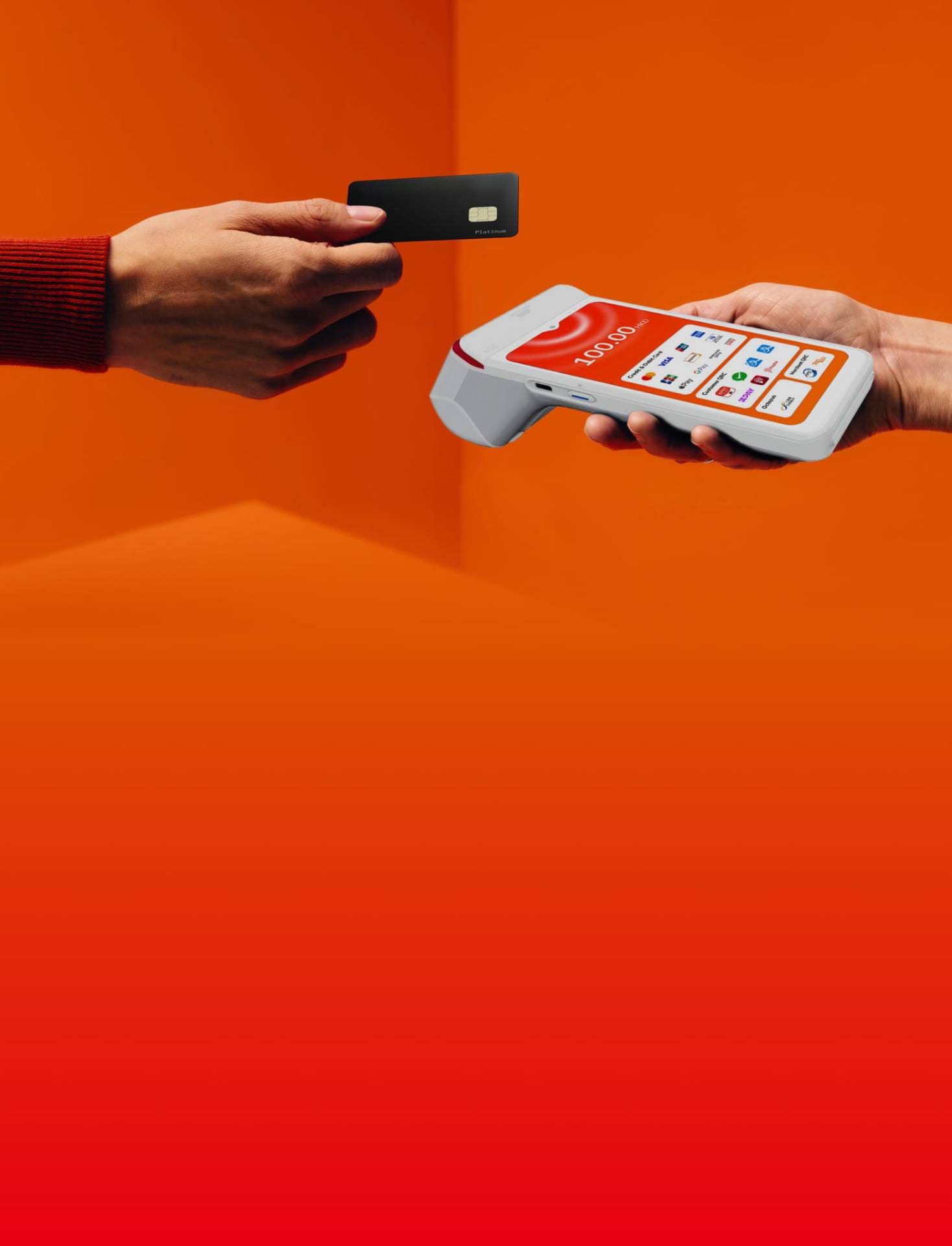 A customer handing a black card to a merchant holding an orange STARPAY smart terminal